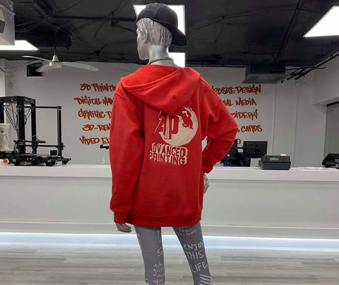 Custom embroidered Advanced Printing hoodie on display in-store
